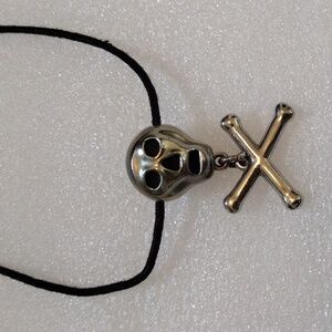 DMA crossbones pendant.
